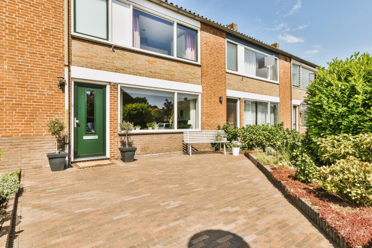 the-facade-of-a-brick-building-with-wooden-door-2026-01-07-07-38-38-utc